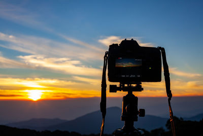 View of camera against sky during sunset