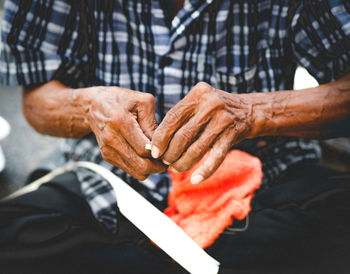 Midsection of man working on wicker