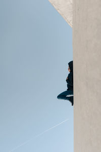 Low angle view of woman against clear sky