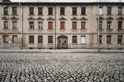 Empty walkway against old residential building