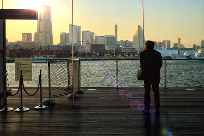 Rear view of man looking at cityscape