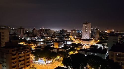 High angle view of illuminated buildings in city at night