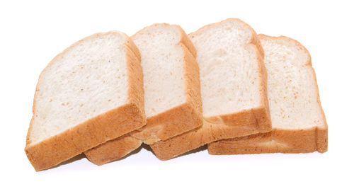 Close-up of breads against white background