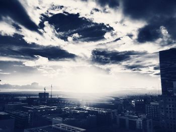 Cityscape against cloudy sky