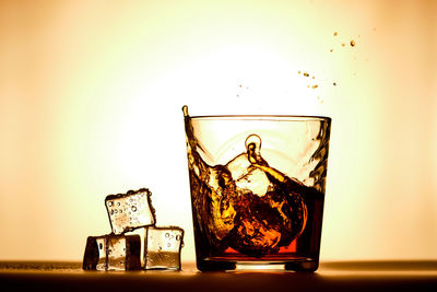 Close-up of glass on table against gray background