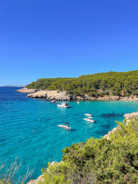 Scenic view of sea against clear blue sky