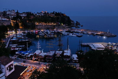 High angle view of illuminated buildings by sea at night