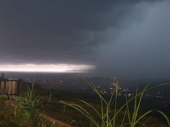 Storm clouds over city at night