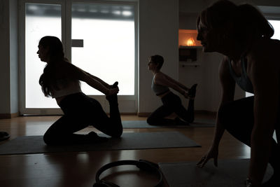 Group of women practicing pilates exercises in class