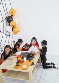 Rear view of people sitting on table