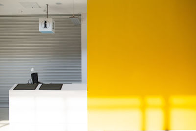 Close-up of yellow door on table