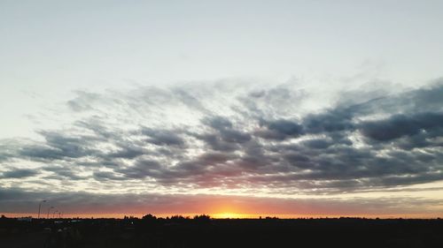 Scenic view of silhouette landscape against dramatic sky