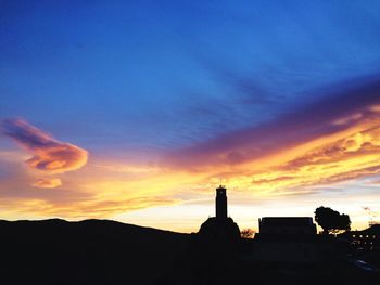 Silhouette of built structure at sunset