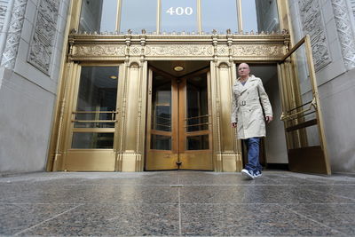 Full length of man exiting from wrigley building