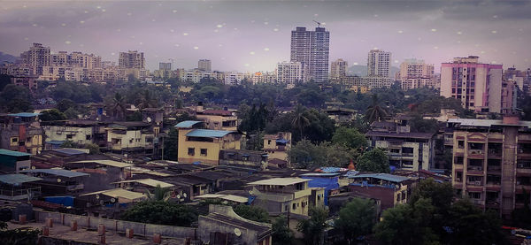 High angle view of buildings in city against sky