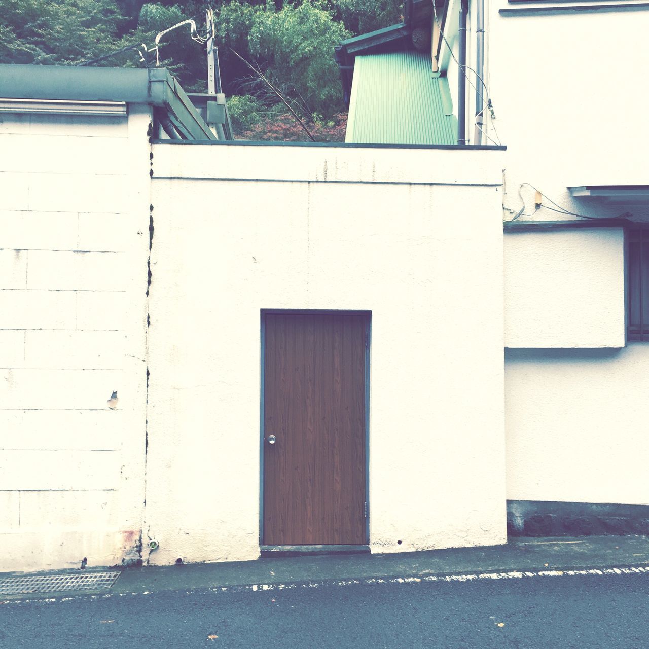 building exterior, architecture, built structure, house, door, wall - building feature, residential structure, day, wall, outdoors, no people, sunlight, street, building, closed, safety, protection, entrance, shadow, residential building