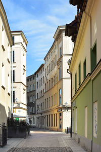 Street amidst buildings against sky in city