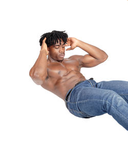 Midsection of shirtless man against white background