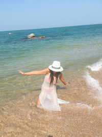 High angle view of woman in sea against sky