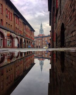 Reflection of buildings in puddle