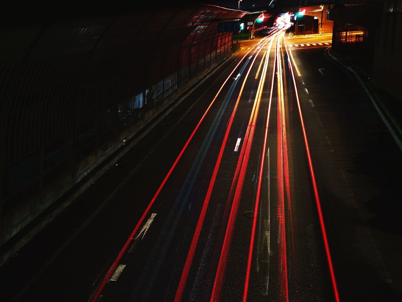 LIGHT TRAILS ON RAILROAD TRACK AT NIGHT