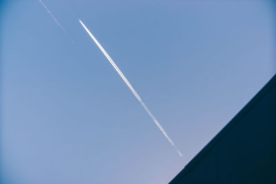 Low angle view of vapor trail