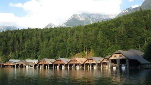 Boathouses in konigssee against trees