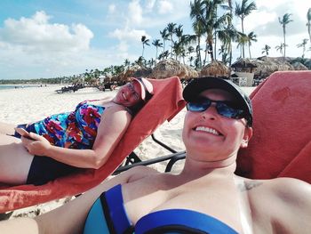 Portrait of smiling women relaxing on beach