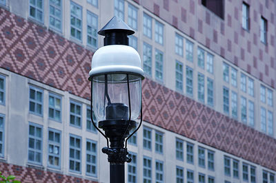 Close-up of street light against building