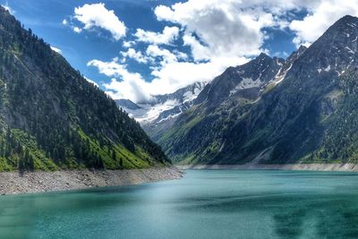 Scenic view of lake and mountains against sky