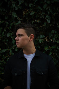 Portrait of young man looking away outdoors