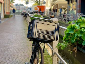 Bicycle on footpath by street in city