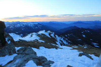Scenic view of snow mountains against sky during sunset