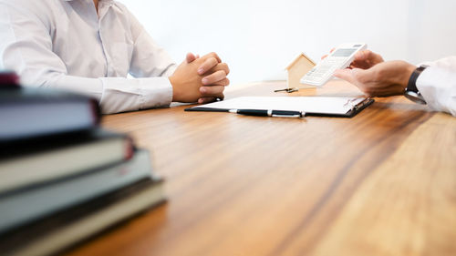 Midsection of people on table