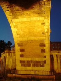 Low angle view of yellow brick wall