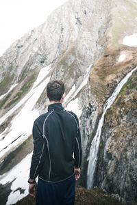 Rear view of man looking at mountains