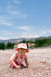 Full length of woman with pink umbrella on field against sky