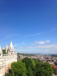 High angle view of city against blue sky