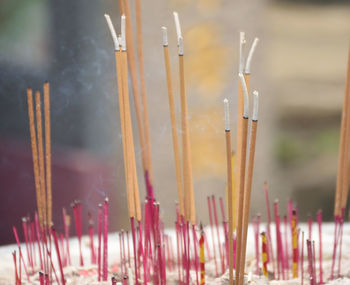 Close-up of burning candles in temple