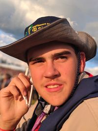 Close-up of young man wearing hat