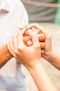 Close-up of couple holding hands