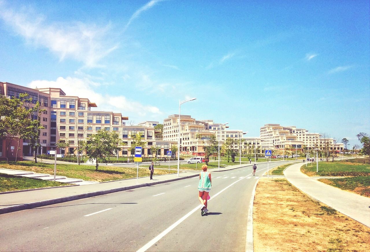 building exterior, architecture, built structure, road, transportation, the way forward, city, street, car, road marking, sky, blue, diminishing perspective, incidental people, land vehicle, vanishing point, day, sunlight, city life, building