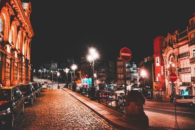 Illuminated city against sky at night