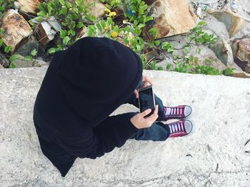 High angle view of man photographing woman