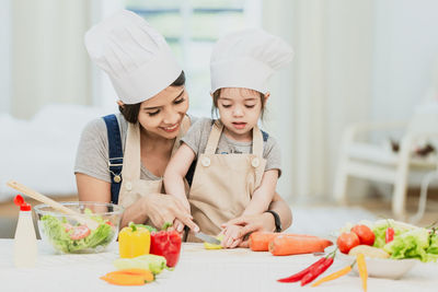 Midsection of woman having food at home