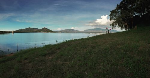 Scenic view of mountains against cloudy sky