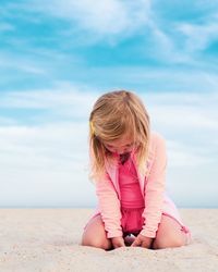 Full length of woman sitting on beach