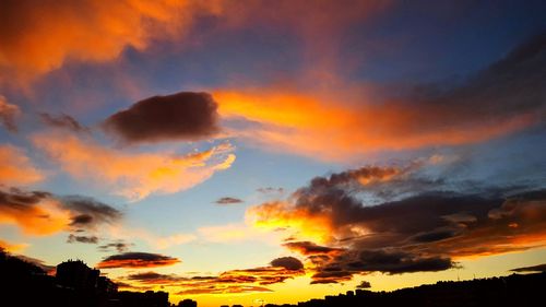 Low angle view of dramatic sky at sunset