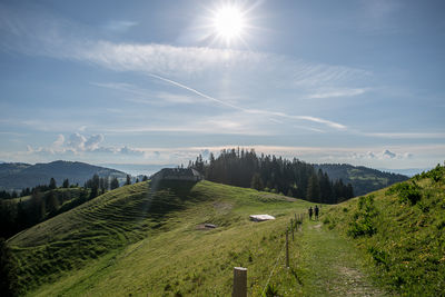 Scenic view of landscape against sky on sunny day