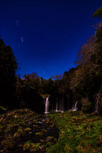 Scenic view of waterfall against sky at night